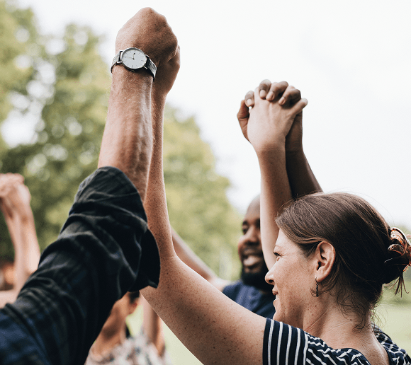 Two hands meeting in a high-five — connection and support